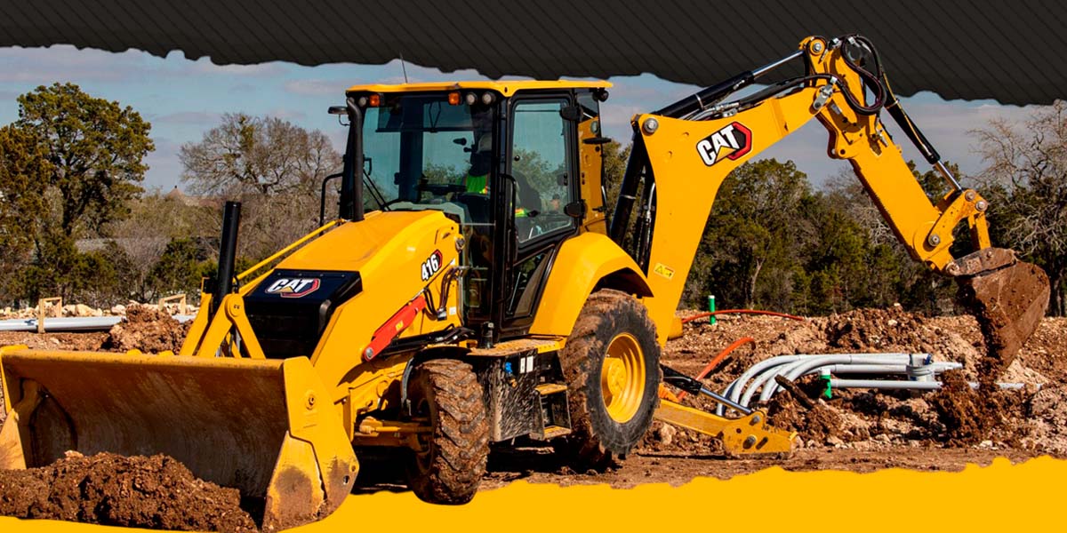 a yellow tractor with a bucket on dirt