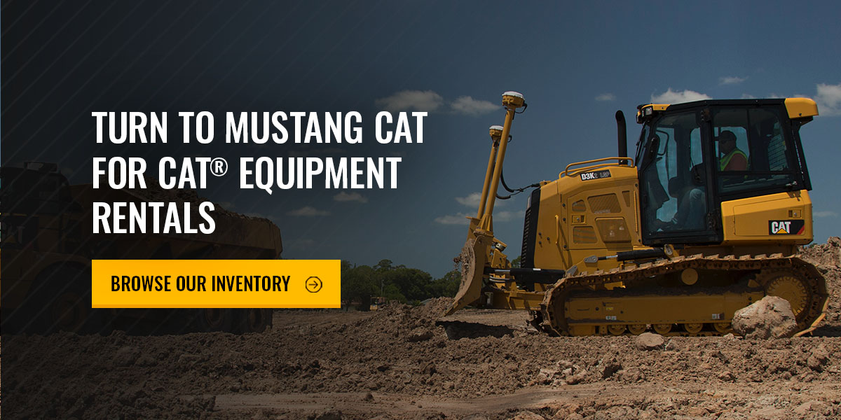 a yellow bulldozer in a dirt field